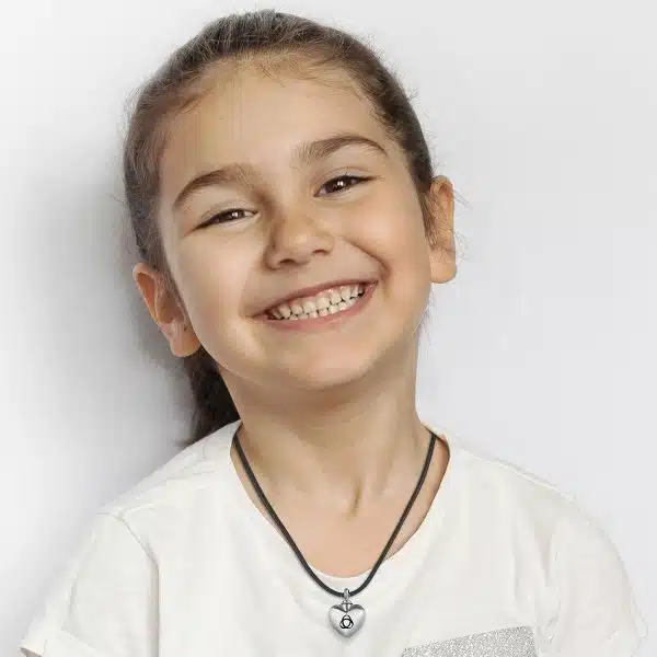 Smiling young girl wearing Aulterra Heart Energy Pendant
